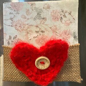 Floral kitchen magnet with heart accent.